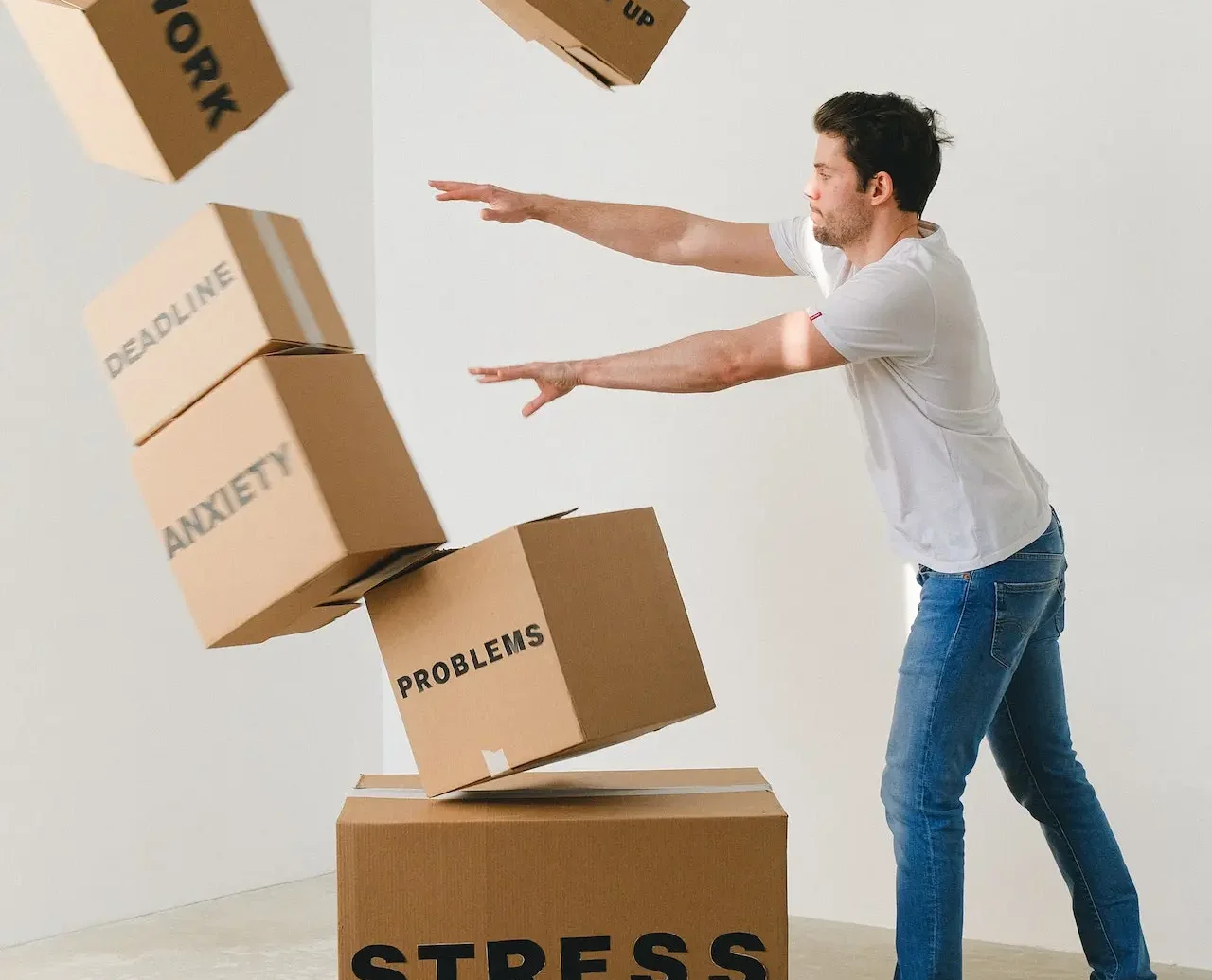 Photo by SHVETS production: https://www.pexels.com/photo/man-falling-carton-boxes-with-negative-words-7203956/